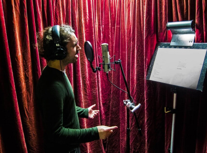 Man singing into studio microphone
