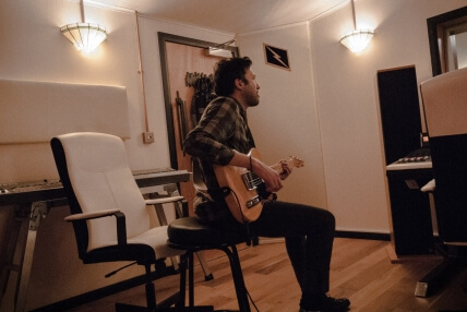 Guitarist recording in studio