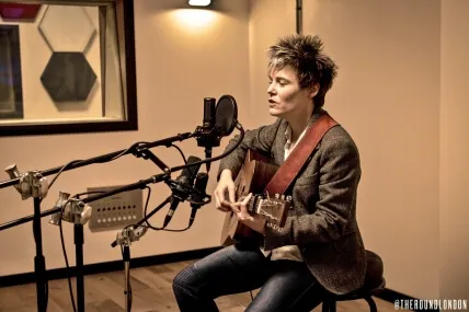 Woman playing acoustic guitar